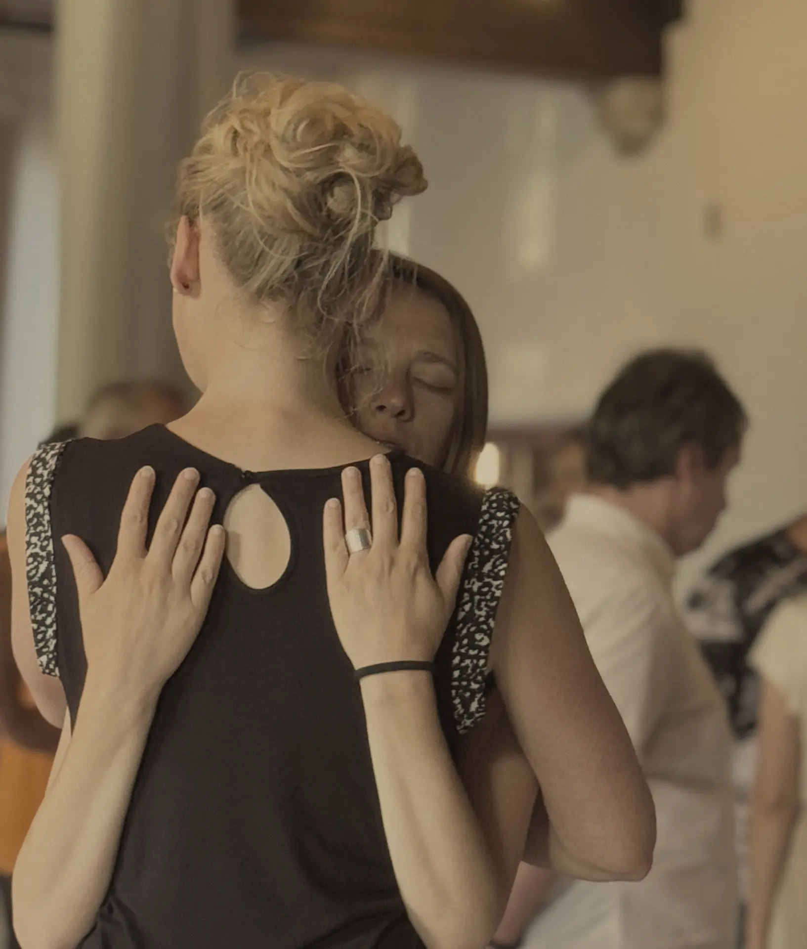 Two women embracing at a SoulKonnect workshop